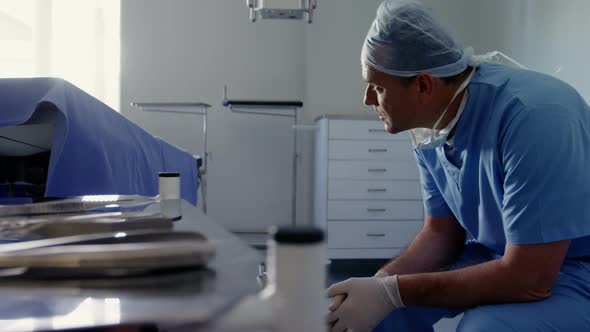 Sad male surgeon sitting on the chair