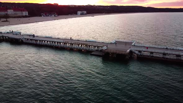 Cinematic pier in the sunset from a bird's eye view. Filming at sunset in Sopot.