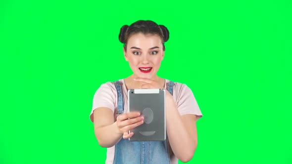 Smiling Girl Talking for Video Chat Using Tablet Computer on Green Screen, Slow Motion
