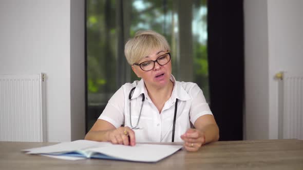 The Pleasant Adult Woman Doctor is Communicating with Patient From Home