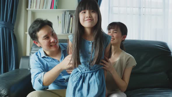 Portrait of Asian happy family, sit on sofa in living room at house.