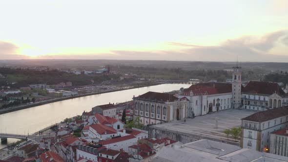 Aerial drone view of Coimbra city and Mondego river at sunset