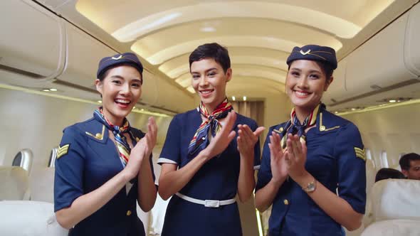 Cabin Crew Clapping Hands in Airplane