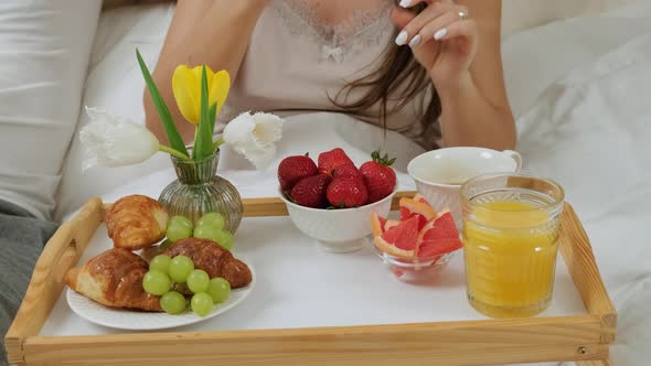 Breakfast in the Bed the Woman Takes a Strawberry To Serve Her Husband