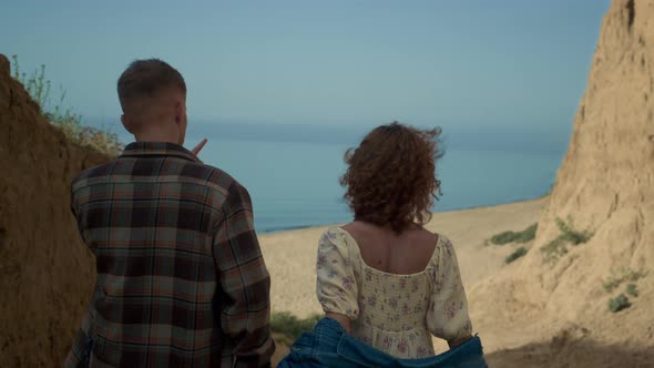 Young Lovers Running Ocean Beach