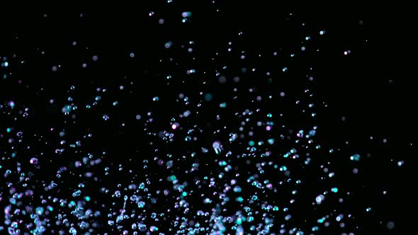 Super Slow Motion Abstract Shot of Flying Neon Water Drops at 1000Fps.