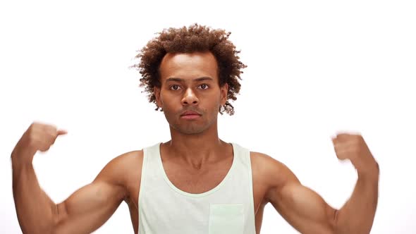 Sportive African Man Smiling Showing Muscles Over White Background Slow Motion