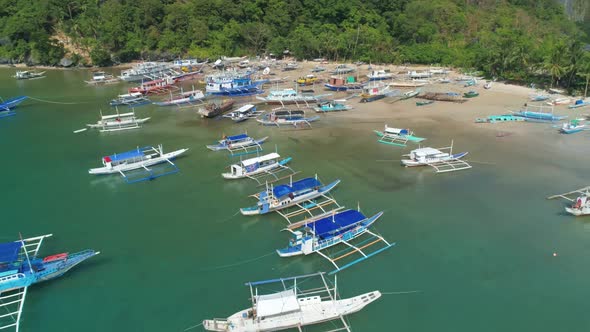 Drone View of a Traditional Philippine Boats on the Surface of the Azure Water in the Lagoon