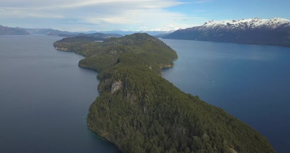 image that runs from above a landscape of lakes and mountains with snow.