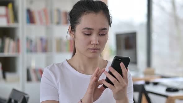 Portrait of Young Asian Woman Having Loss on Smartphone 