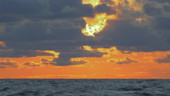 Romantic vibrant scenic red sunset over the Baltic beach at Liepaja with vibrant blue clouds, wide s