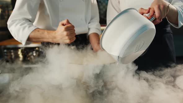 Professional kitchen: liquid nitrogen is added during the cooking of a molecular dish