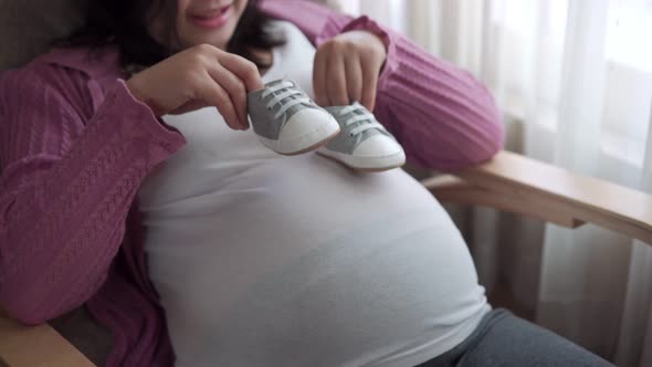 Happy Pregnant Woman and Expecting Baby at Home