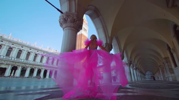 Girl with Beautiful Pink Dress Walks in San Marco Square