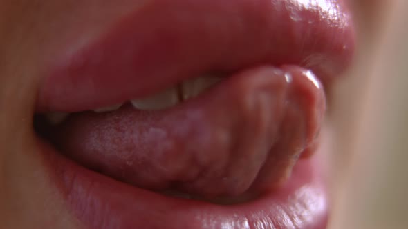 Extreme Closeup Female Tongue Touching Teeth in Slow Motion