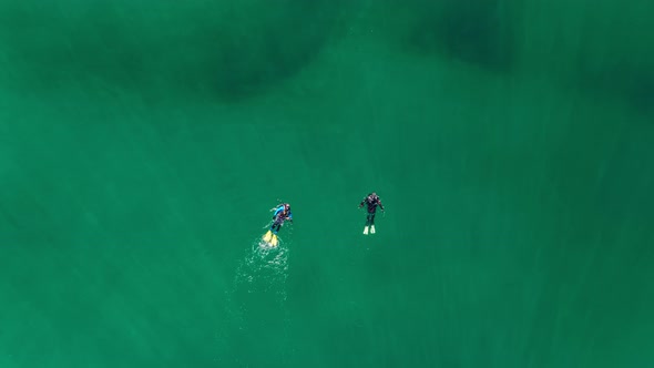 Drone Footage of Couple of Divers Snorkeling in Deep Crystal Clear Ocean