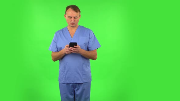 Happy Medical Man Texting on Him Phone. Green Screen