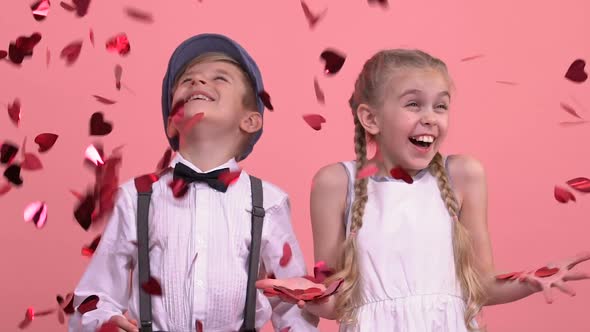 Cute Children Enjoying Rain From Bright Heart-Shaped Confetti, St Valentines Day