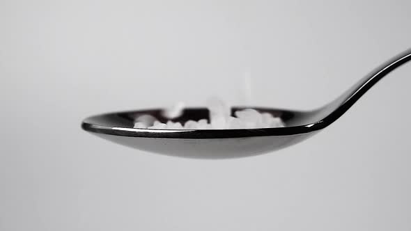 Large Crystals of Sea Salt Fills a Spoon in Slow Motion