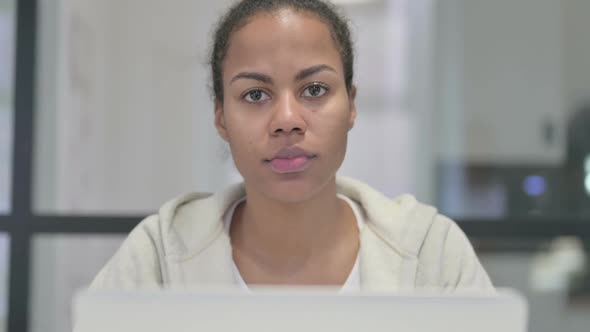 Close Up of African Woman with Laptop Shaking Head As No