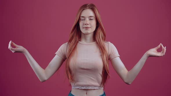 Smiling Young Redhead in Pink Casual Tshirt Isolated on Pink Background