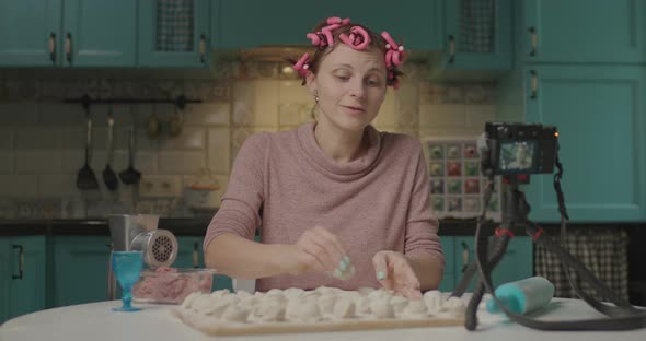 Female Food Blogger Cooking Dumplings and Recording Video on Camera. Smiling Young Woman with Hair