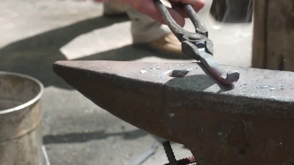 Modern Blacksmith Forges Hot Metal With A Hammer