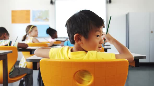 School kids studying in classroom