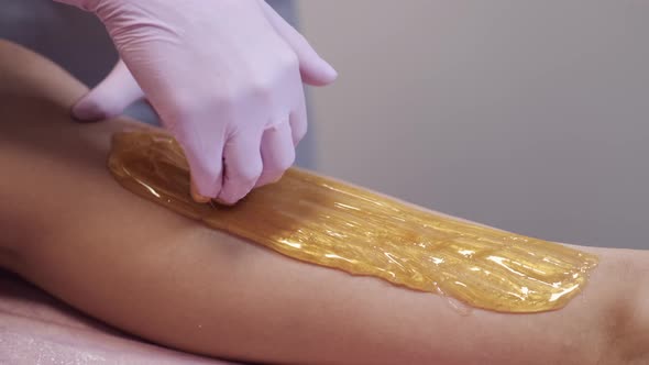 Closeup of Placing Wax on Client's Leg for Hair Removal