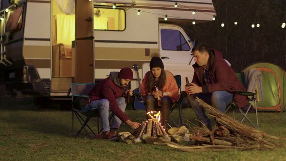 Friend of a Couple Helping To Light the Camp Fire