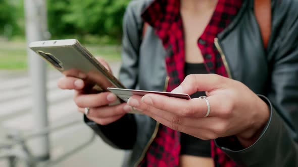 Hands of woman holding smartphone and credit card