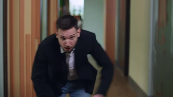 Rushed Caucasian Young Businessman Running Along Corridor Resting for a While and Leaving