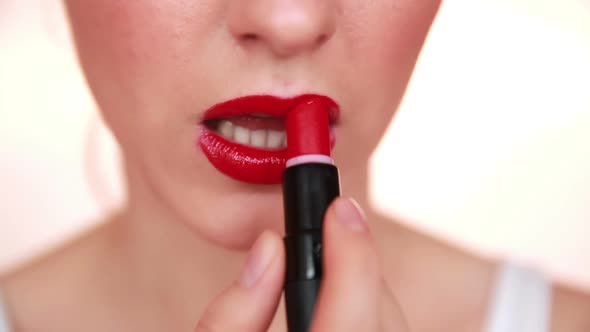 Woman with Red Lips Applying Make Up