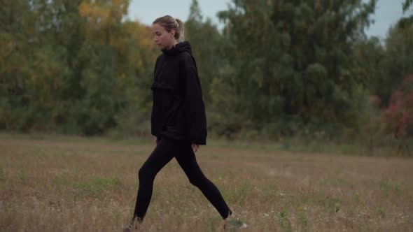 slowmotions sport female walking in a field