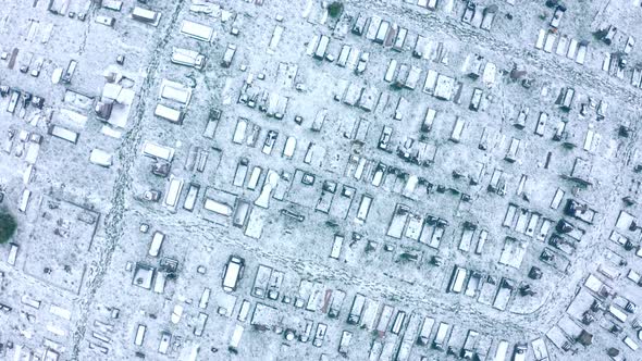 descending top down aerial drone shot of kensal green cemetary graveyard London in winter covered in