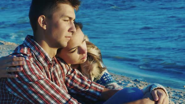 Romantic Couple Relaxing on the Beach, She Clung To the Guy