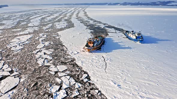 Icebreakers breaking the ice on Vistula river. Poland in winter