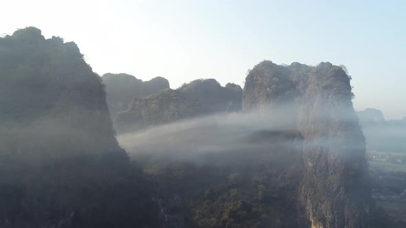 Aerial footage of beautiful sunrise over karst mountain peak landscape