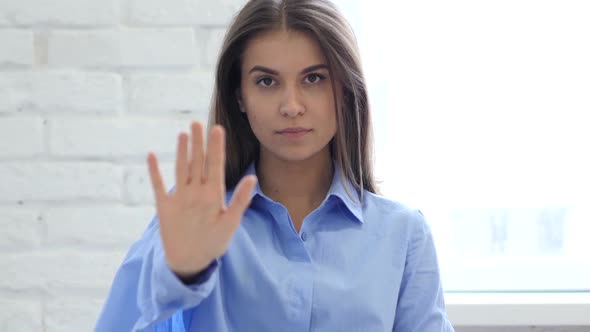 Beautiful Young Woman Gesturing Stop Sign with Hand