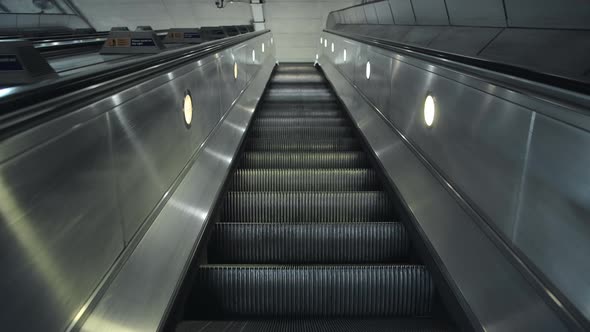 Quiet escalator in London Underground tube train station in Covid-19 Coronavirus pandemic lockdown i