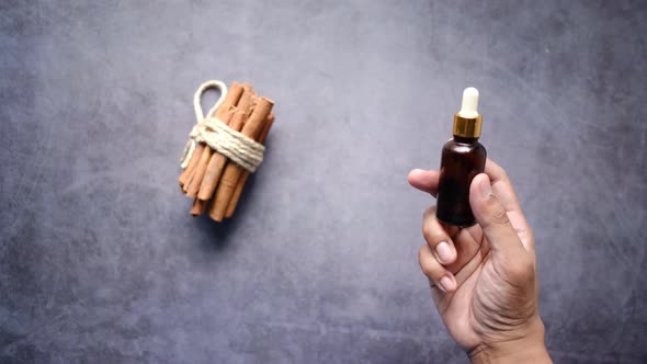 Holding Cinnamon Essential Oil Container Top View