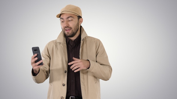 Young man making a video call from his mobile phone while