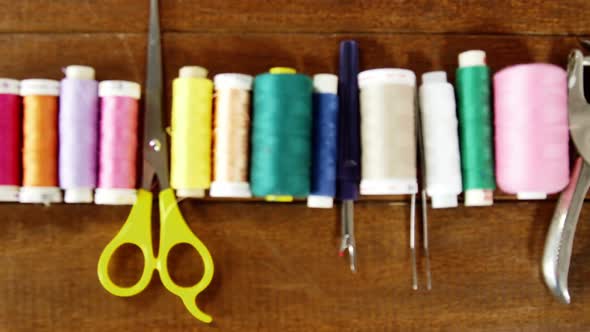 Close-up of set of threads and sewing tools