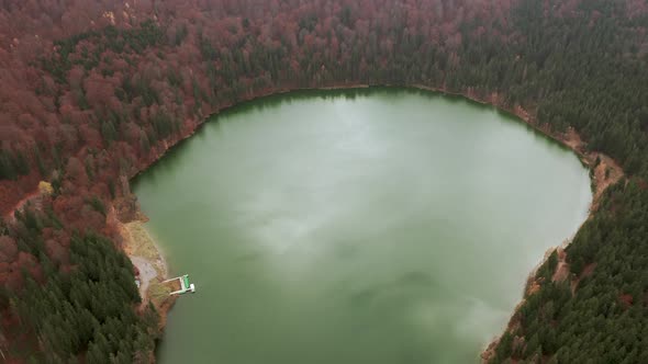 Bird's eye ascending shot above Lake Sfanta Ana in crater of Ciomadul volcano