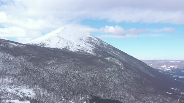 Pyramid shaped peak of mountain Rtanj under snow 4K drone video