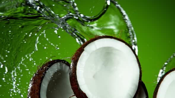 Super Slow Motion Shot of Flying Fresh Coconuts and Water Side Splash at 1000Fps.