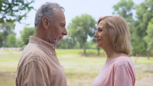 Senior Man and Woman Holding Hands, Looking Each Other With Love, Happy Couple