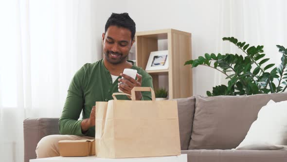 Indian Man Checking Takeaway Food Order at Home