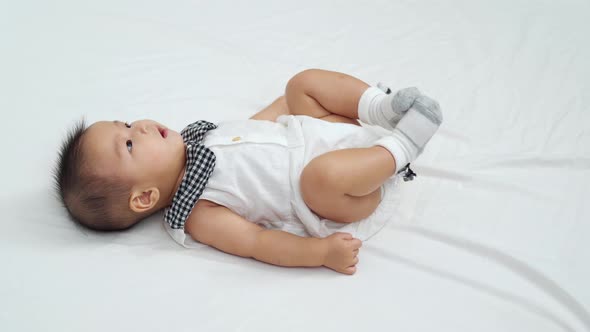 baby lying in a bed and sneeze