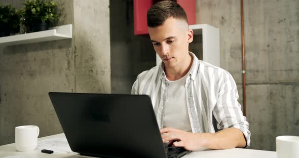 Man Working on Laptop in Office